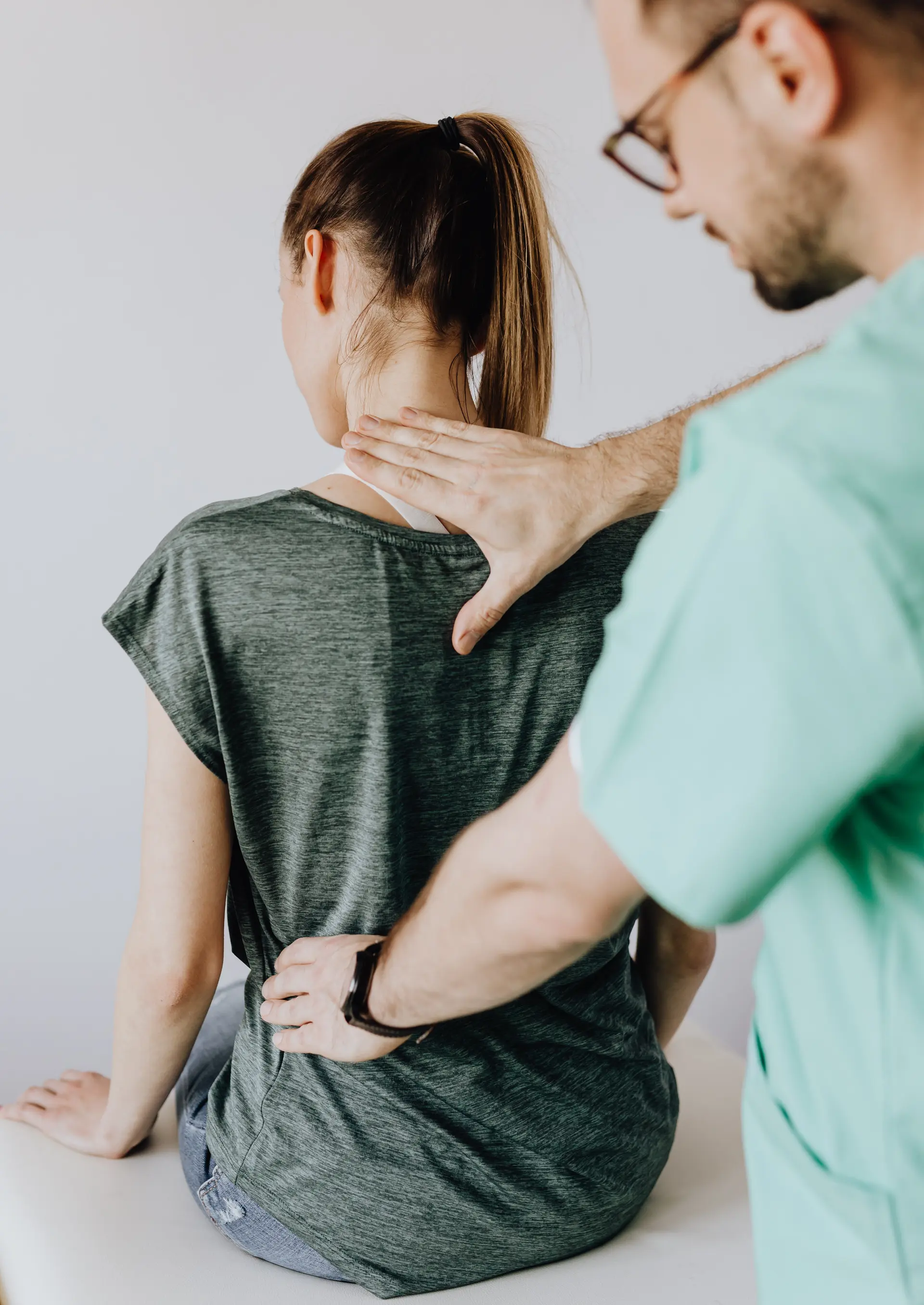 Doctor looking at a patient's back